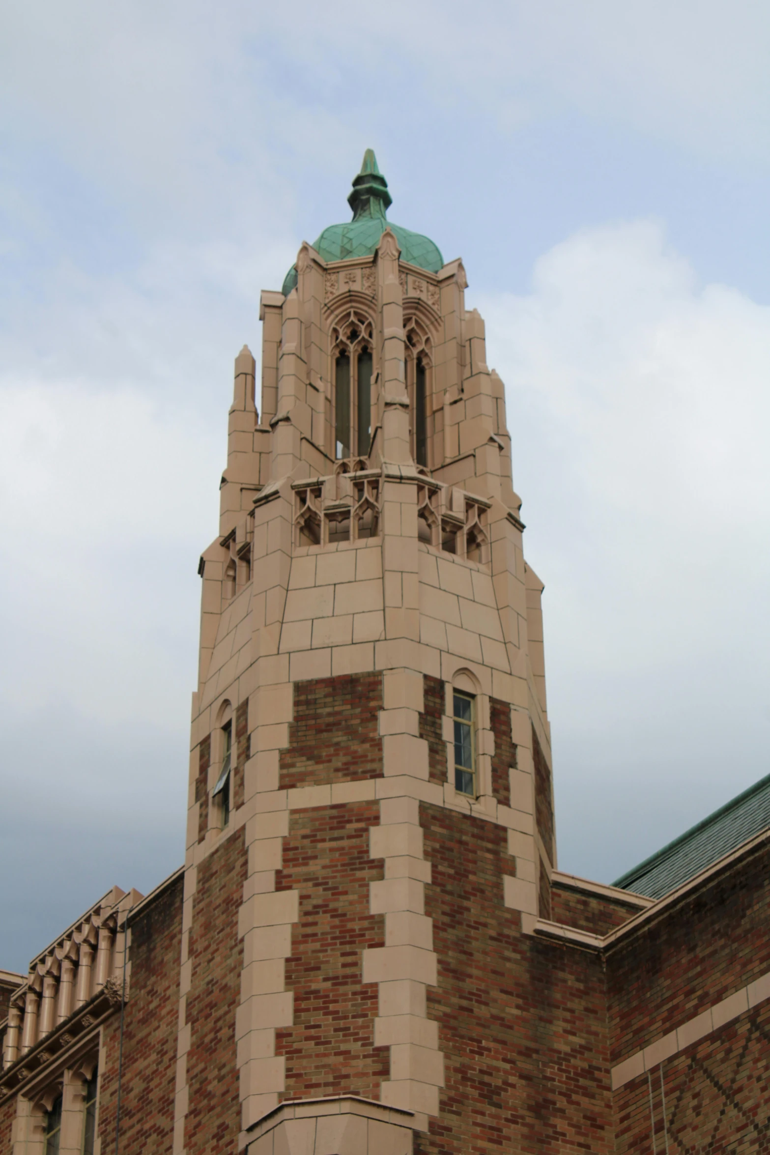 a tall brick clock tower on the side of a building