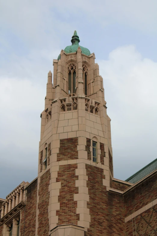 a tall brick clock tower on the side of a building