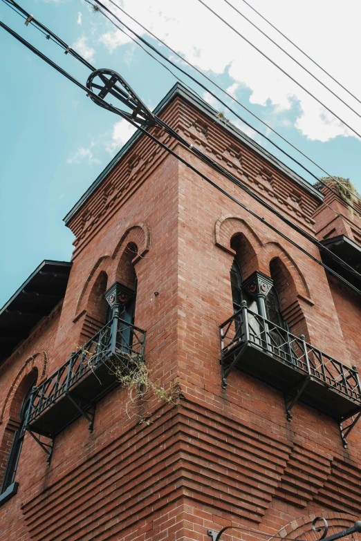 the corner of a building that has a small balcony on it