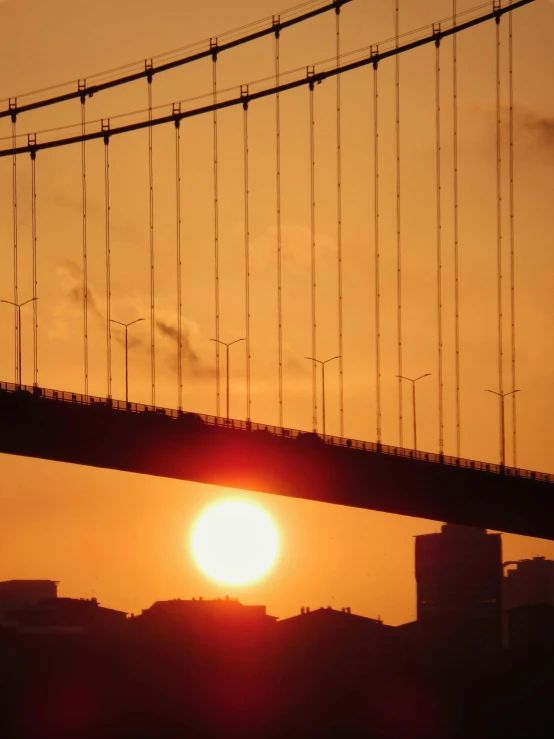 a long bridge with a red light at the end