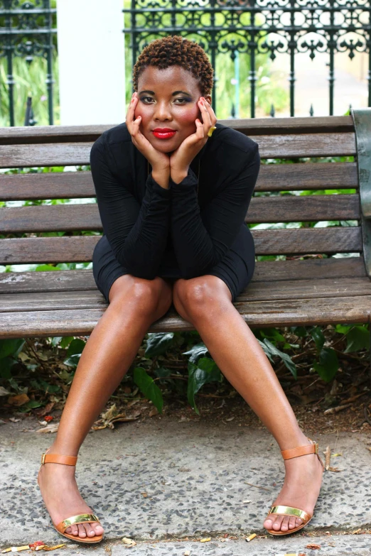 a young woman is sitting on a bench