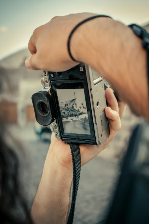 a person is holding up a vintage camera