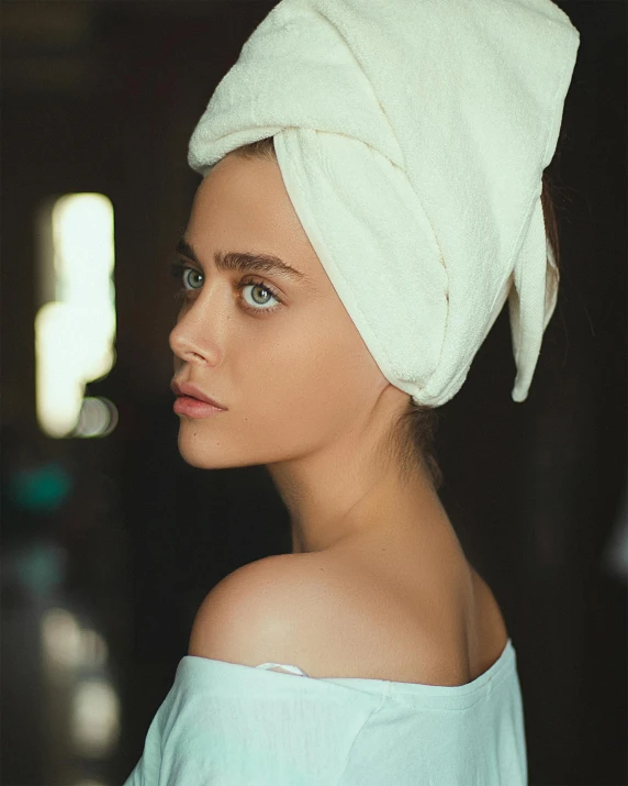 a young lady with a towel on her head