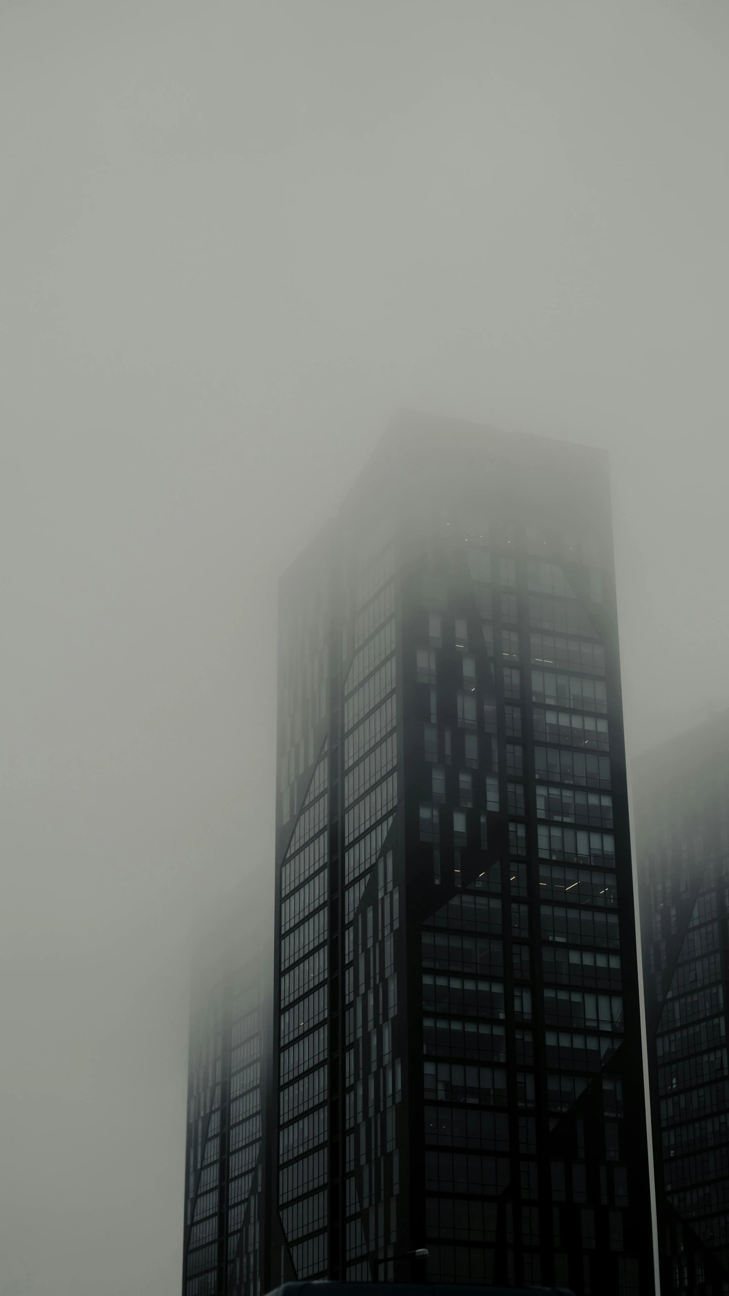 some skyscrs on a foggy day with traffic visible