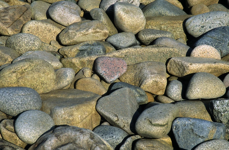 a small heart stone sitting on some rocks