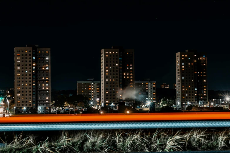 the bright lights of skyscrs are lit up in the night sky