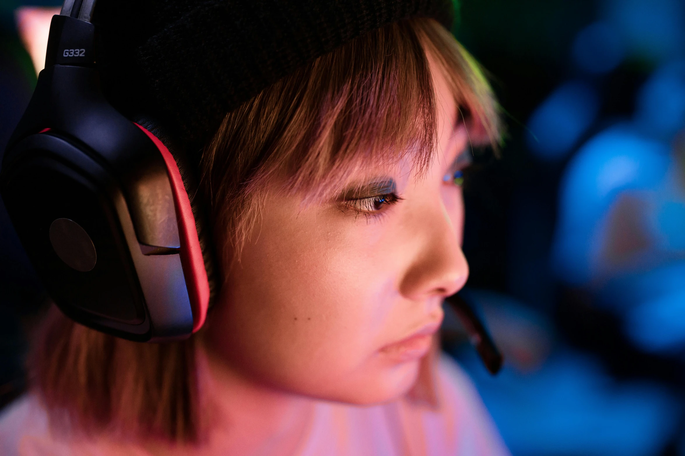 a young person in gaming headphones looks away