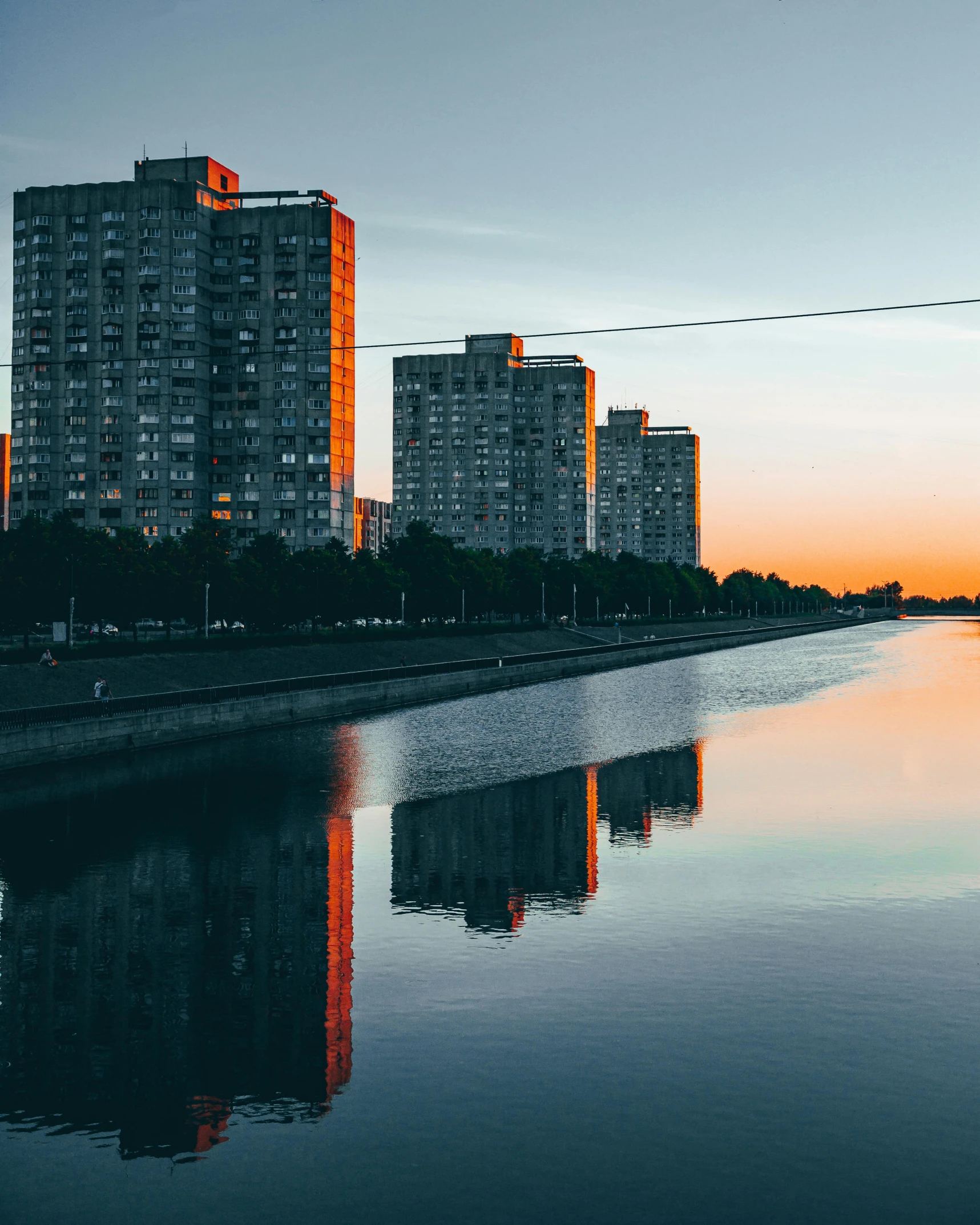 buildings are next to a body of water in front of a bridge