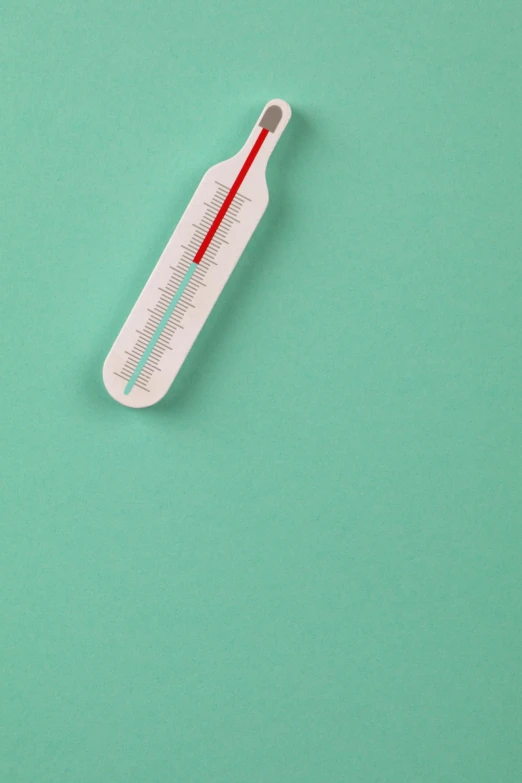 an thermometer that shows the temperature of air on a mint green background