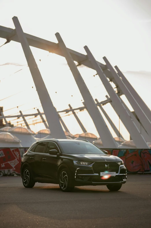 the black suv is parked in front of a building