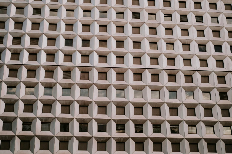 a concrete structure with holes and windows