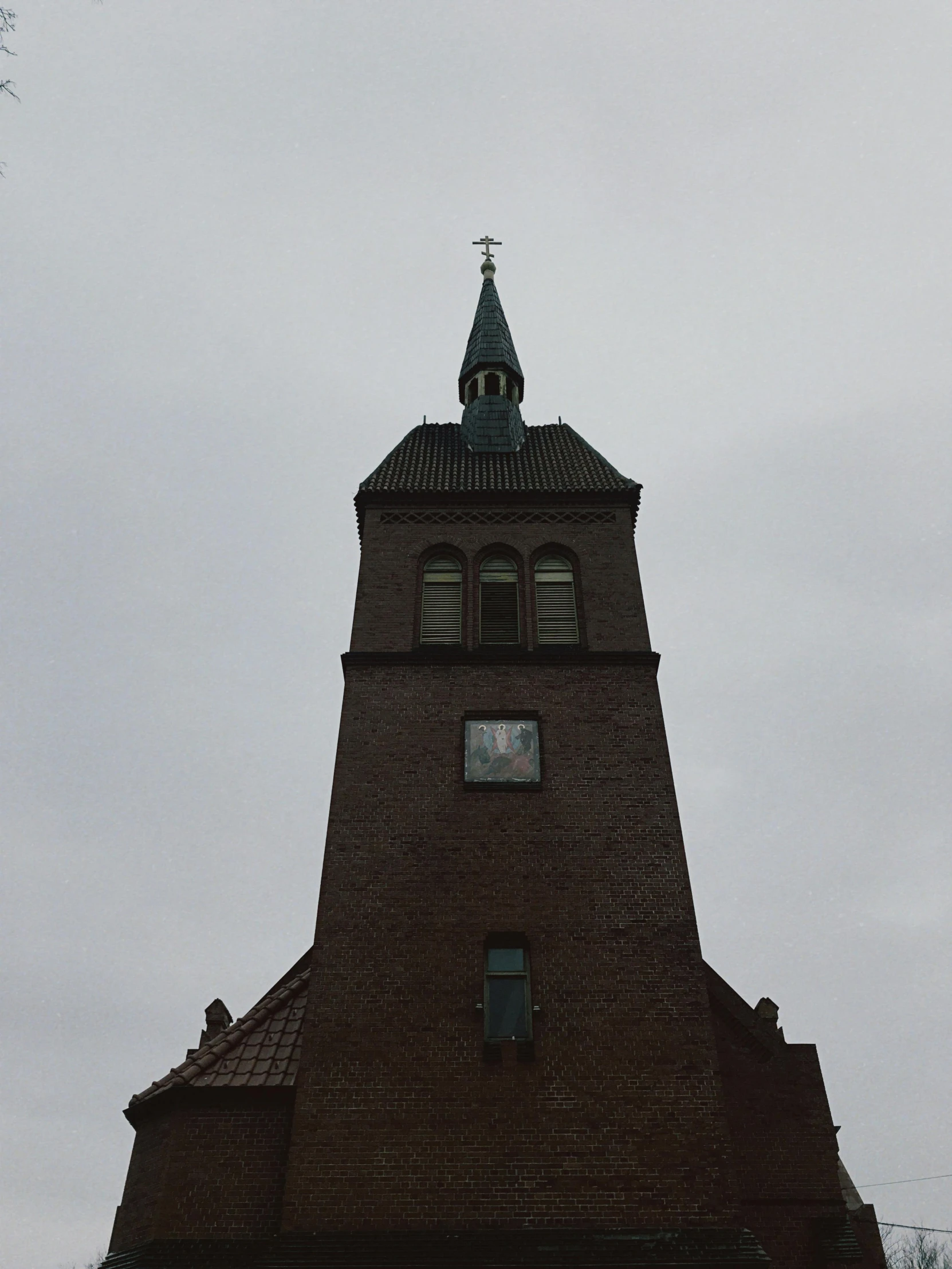 a tall clock tower against a cloudy sky