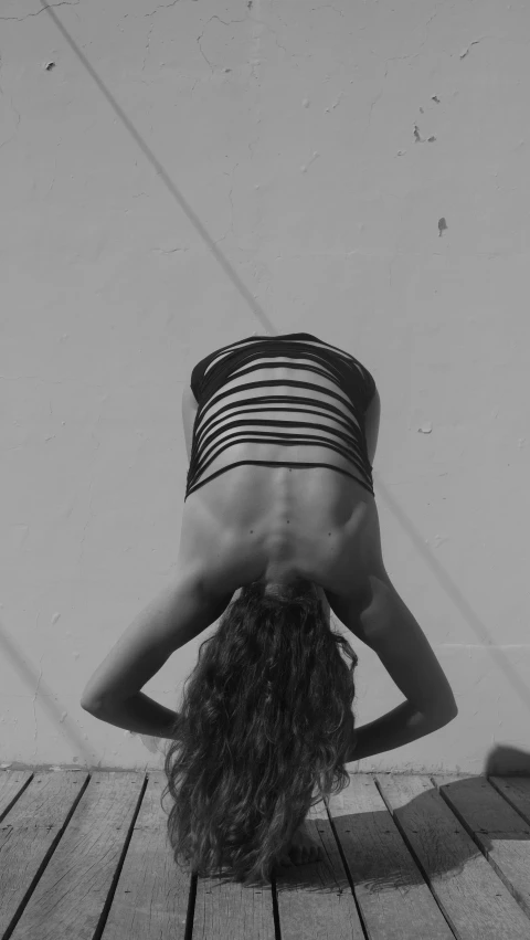 a woman doing yoga poses on a wooden floor