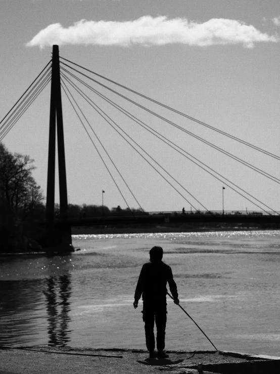 person walking through water with a cane on a leash