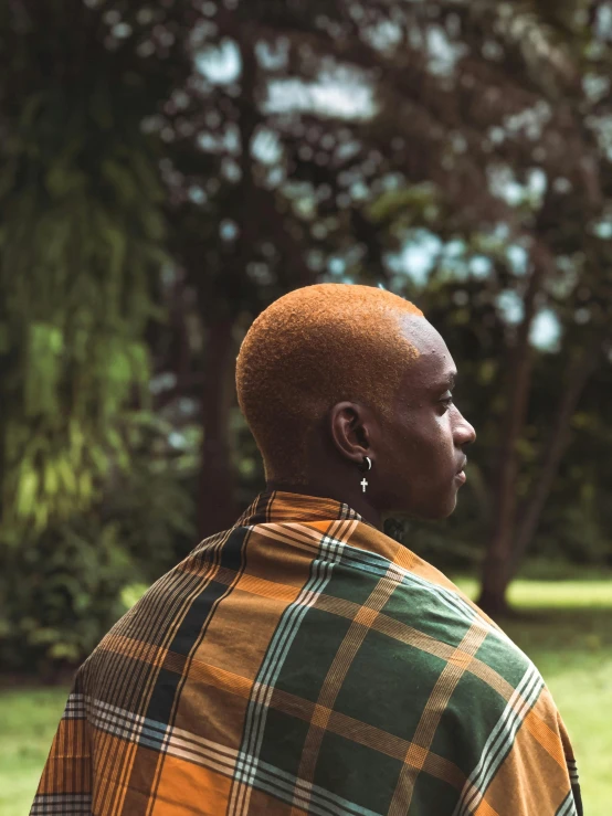 an african american man in a green and yellow plaid shirt