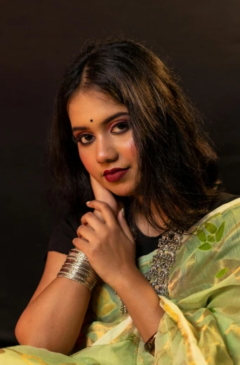 a woman posing for a portrait in a saree