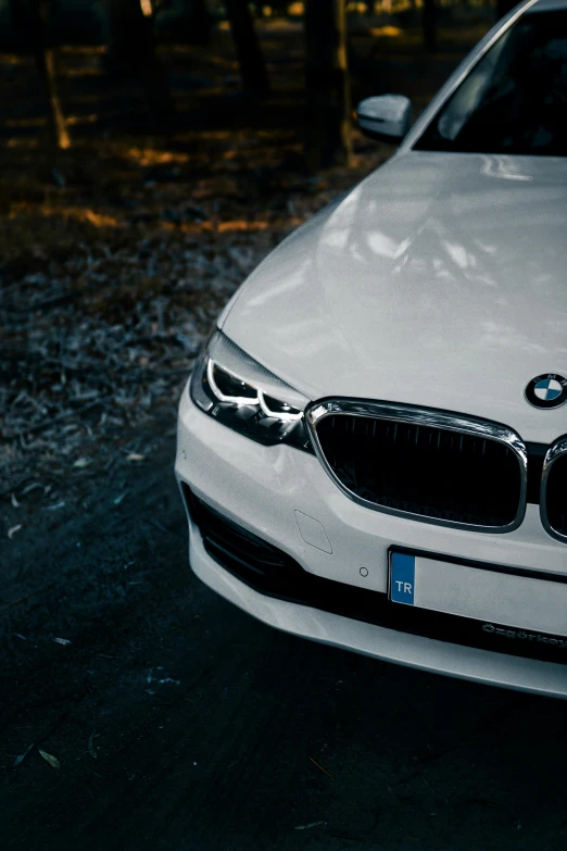 a white car is parked on the side of a road