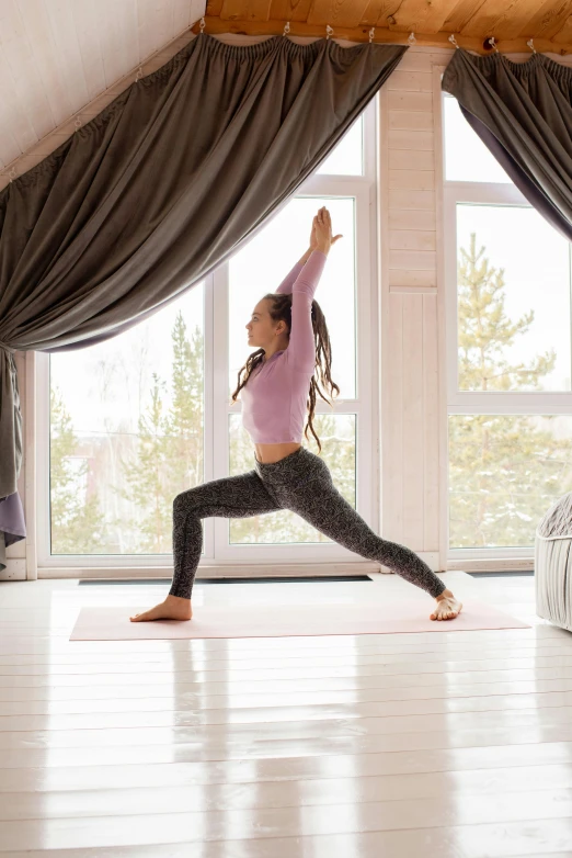 woman doing yoga on white floor in a room