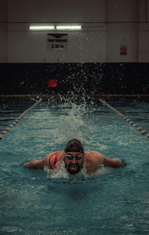 an olympic swimmer is swimming in a swimming pool