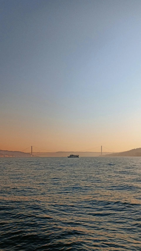 a boat that is in the water near a hill