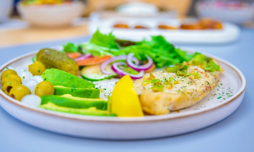 a plate with mixed vegetables and chicken on top