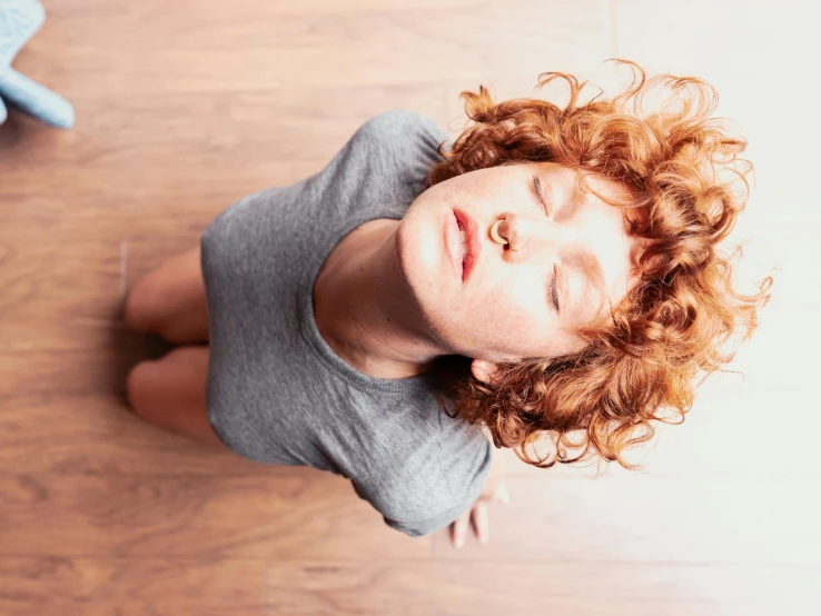 a woman laying on the floor looking up