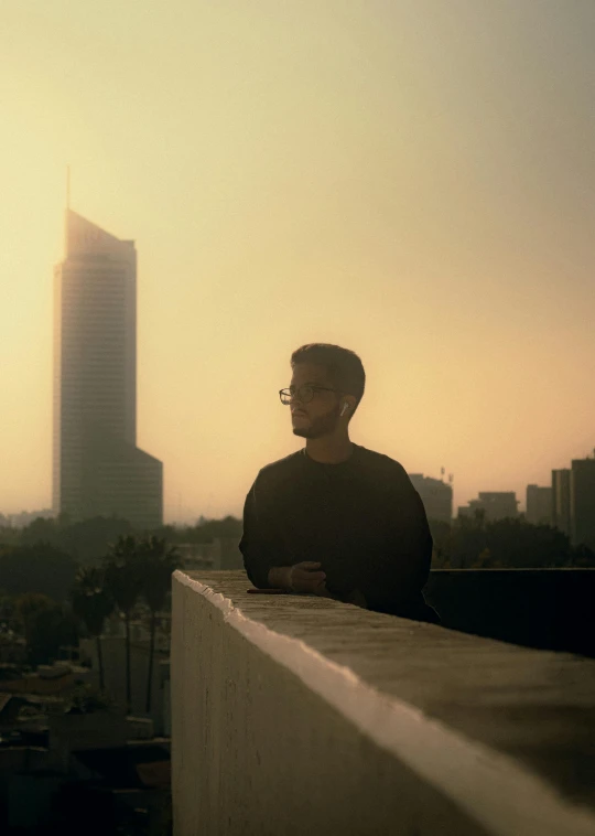 the silhouette of a man in front of a city skyline