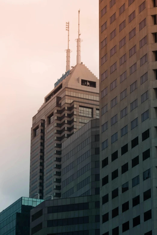 two skyscrs with towers and a sky line