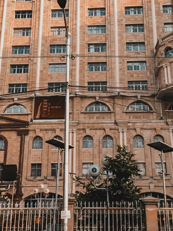 large building with a fence and a street light