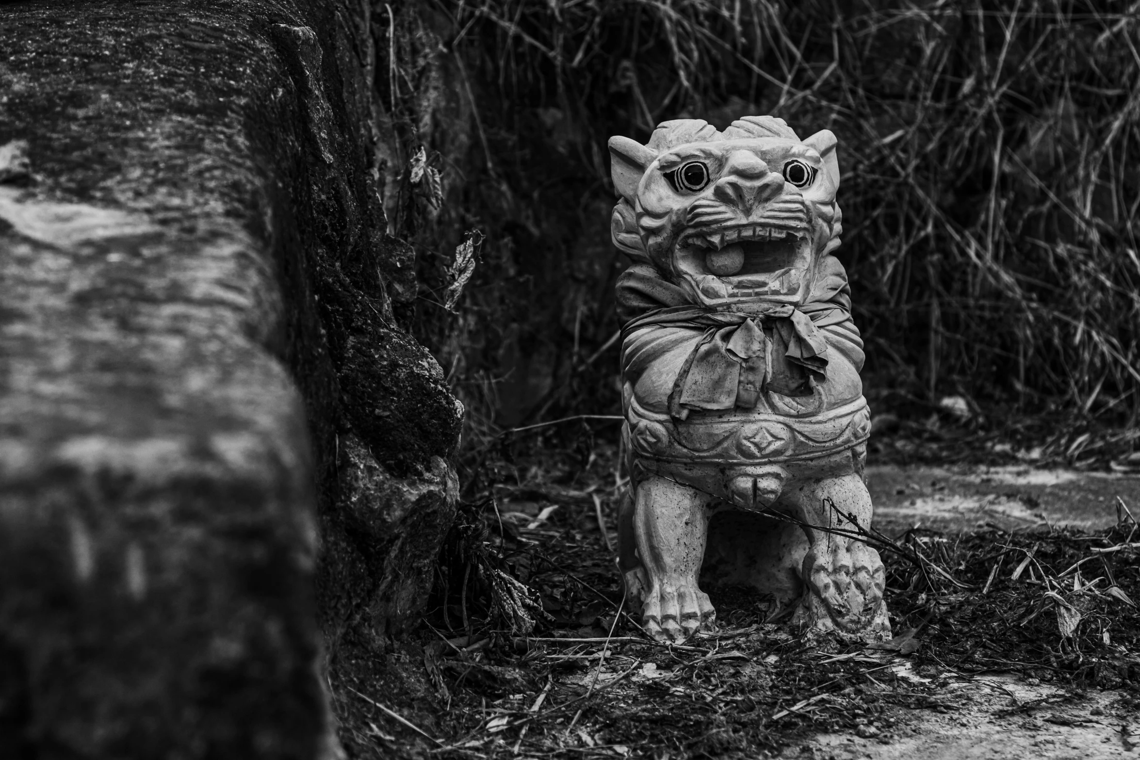 a carved animal standing next to a wooden structure