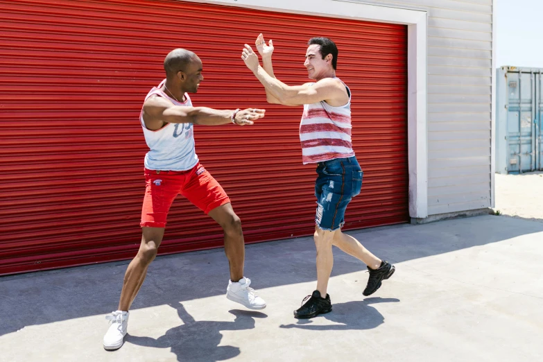 two men doing exercises near a garage door