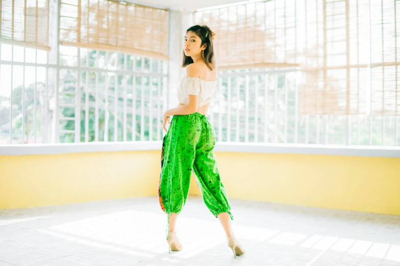 the young woman is standing in a white room