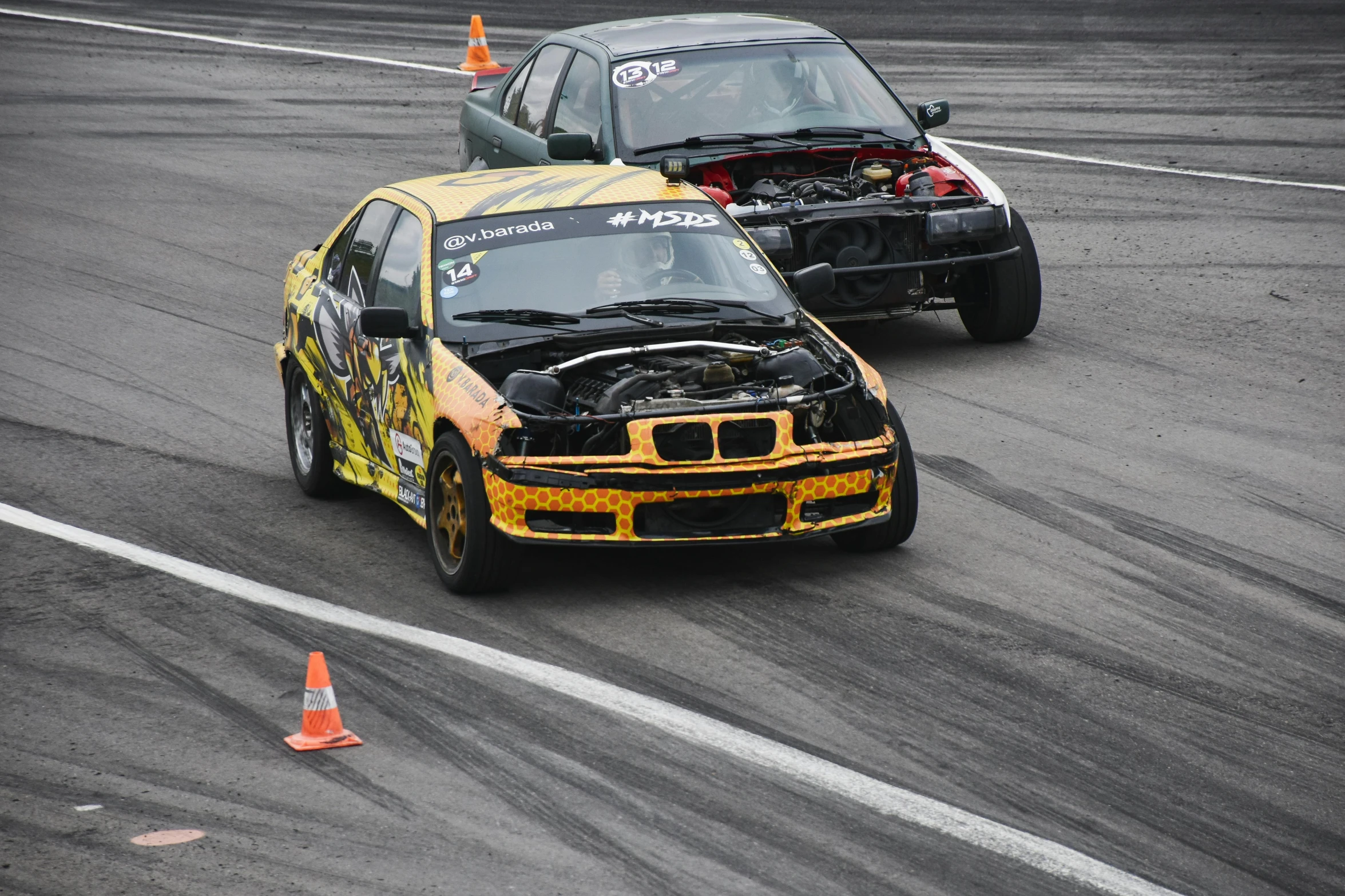 two cars racing on a race track near each other