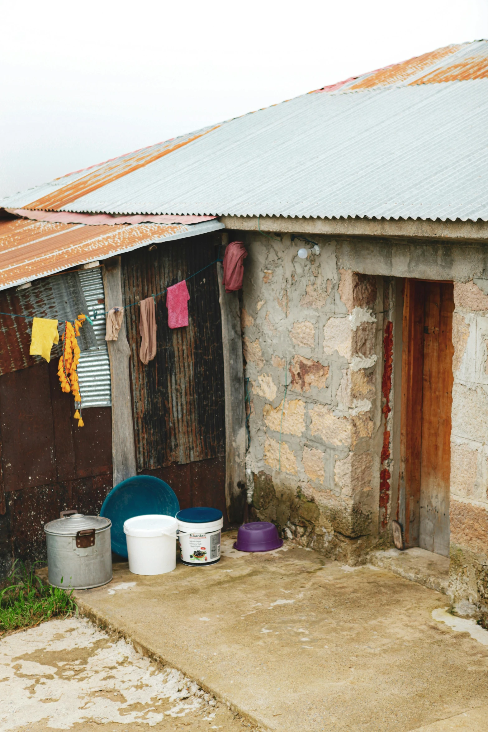 some buckets a building some clothes and a door