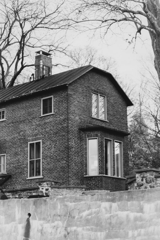 an old brick building is pictured on the side of a road