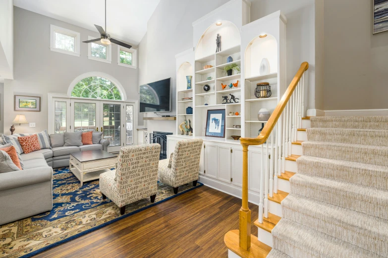 a clean, spacious family room with wooden floors