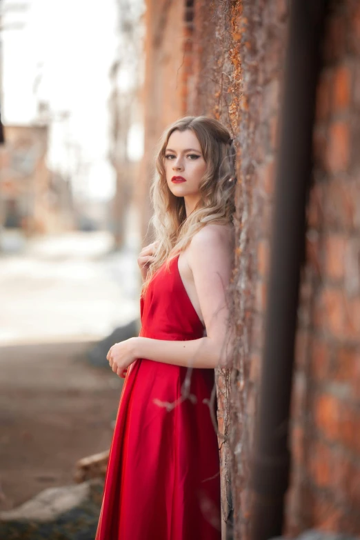 the woman is standing alone in an empty room