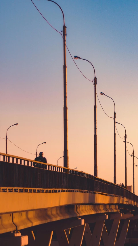 a light pole and street lights over an overpass