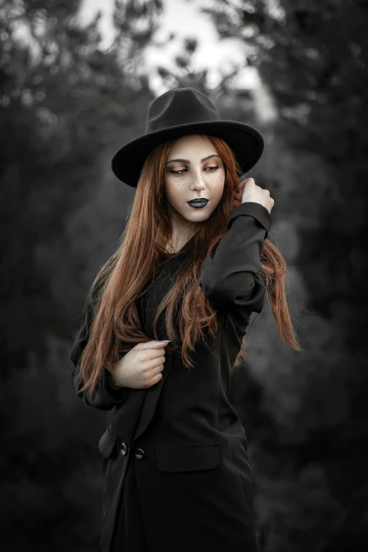 a woman wearing black clothing and a hat