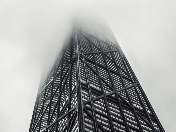 a very tall building with a lot of fog