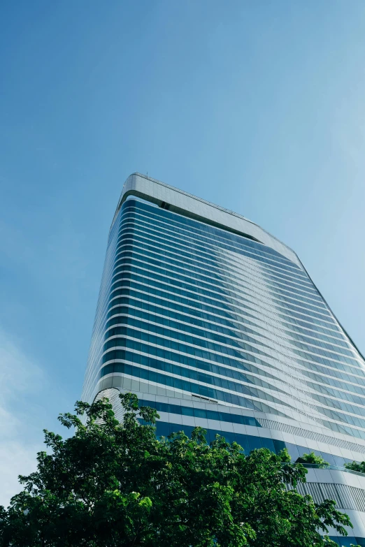 a high rise building with some trees in front