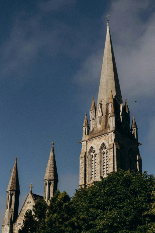 a tall church with a very steeple and trees in the background