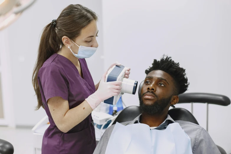 a man in a wheelchair with a person wearing a mask and a face mask