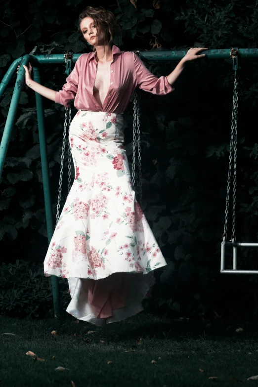 a beautiful woman is posing on a swing