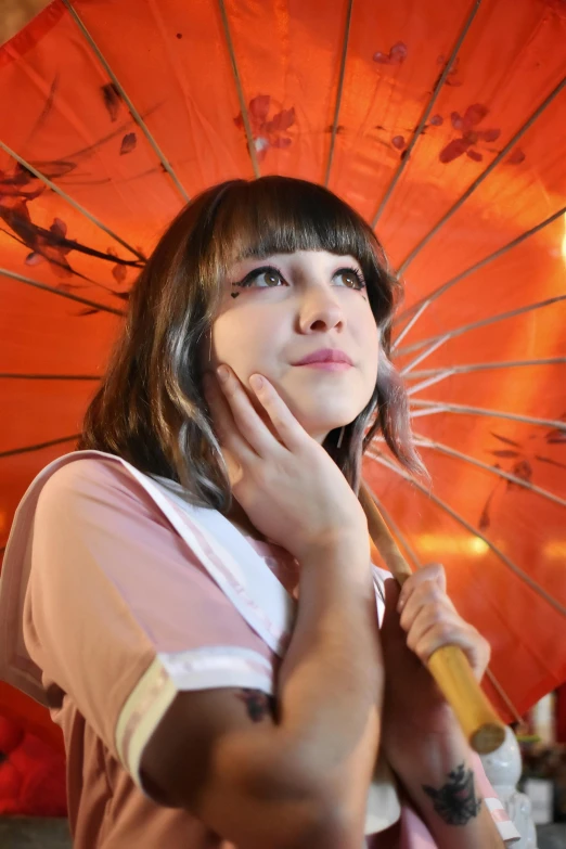 the girl is holding a colorful umbrella outside