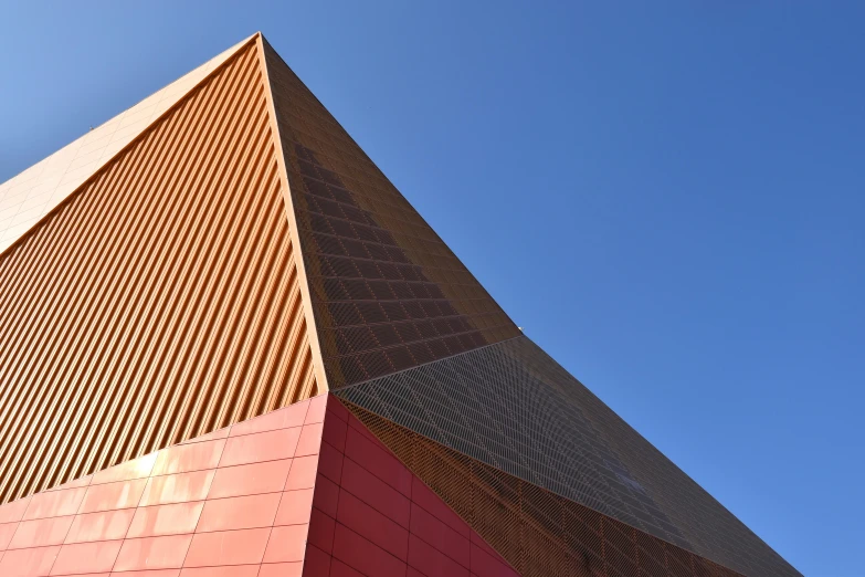 a tall red building sitting under a blue sky