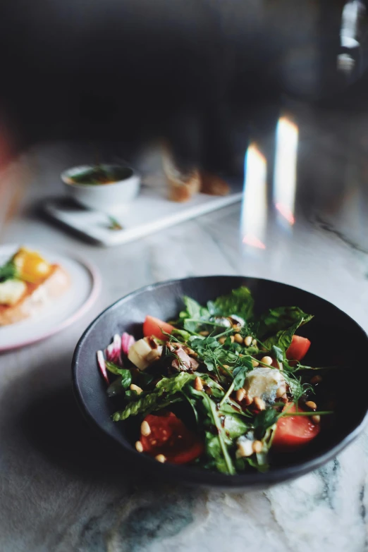 a salad is on the table with other food