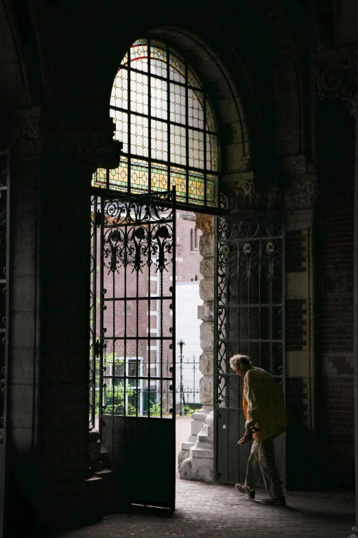 person with yellow umbrella near entrance to building