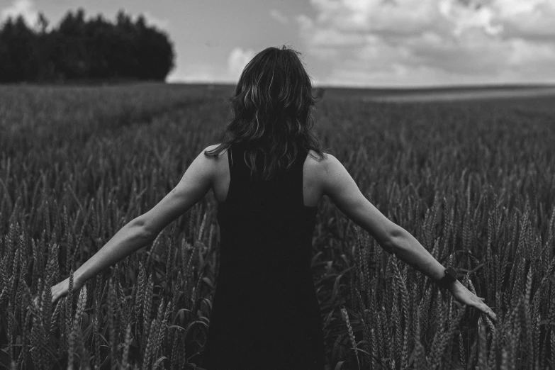 a girl standing in the middle of a field