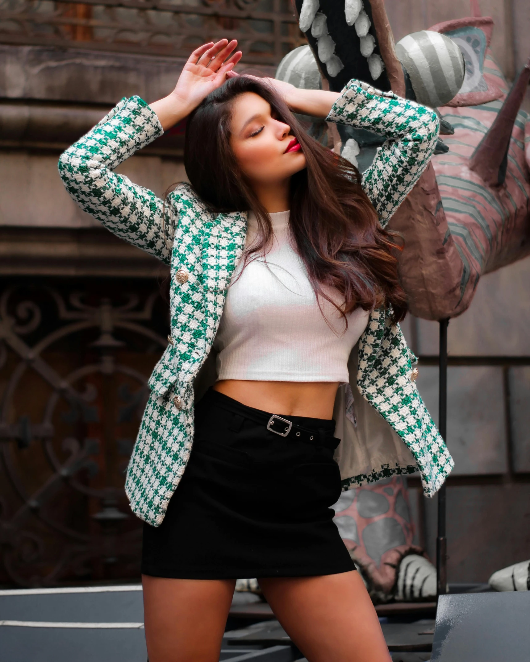 a woman with very tight black pants and a jacket posing for a picture